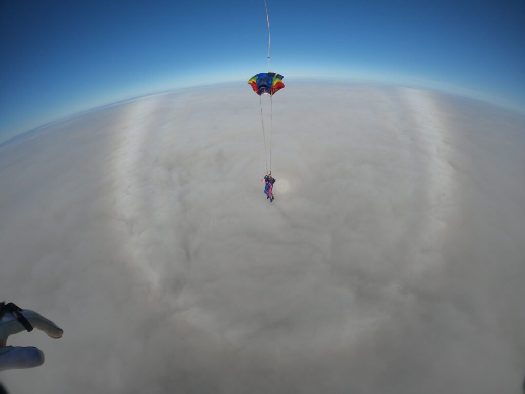 Tandem skydiver open parachute